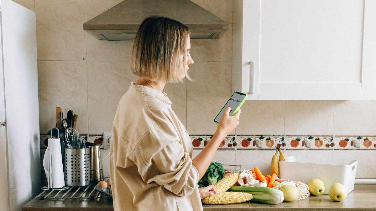 woman calling a creditor from her kitchen before a bill is due