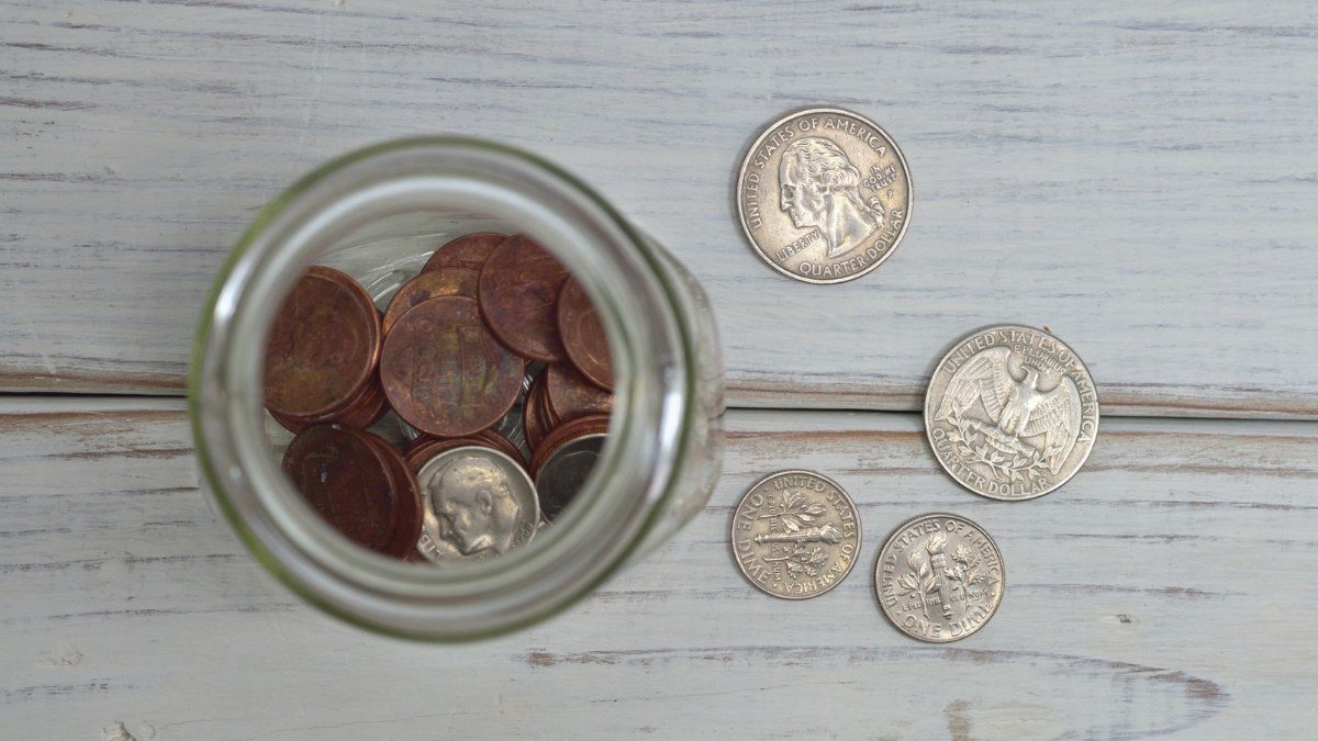 Hands sorting paper receipts and statements to find extra money for debt payoff