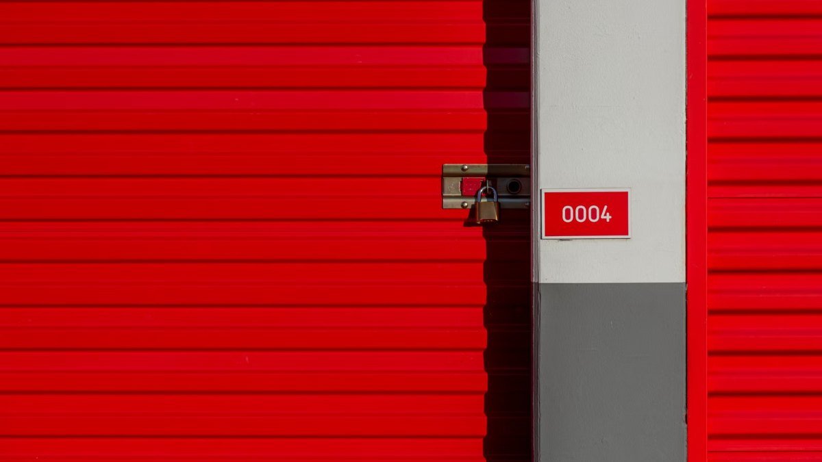 row of red self storage unit doors at a storage facility