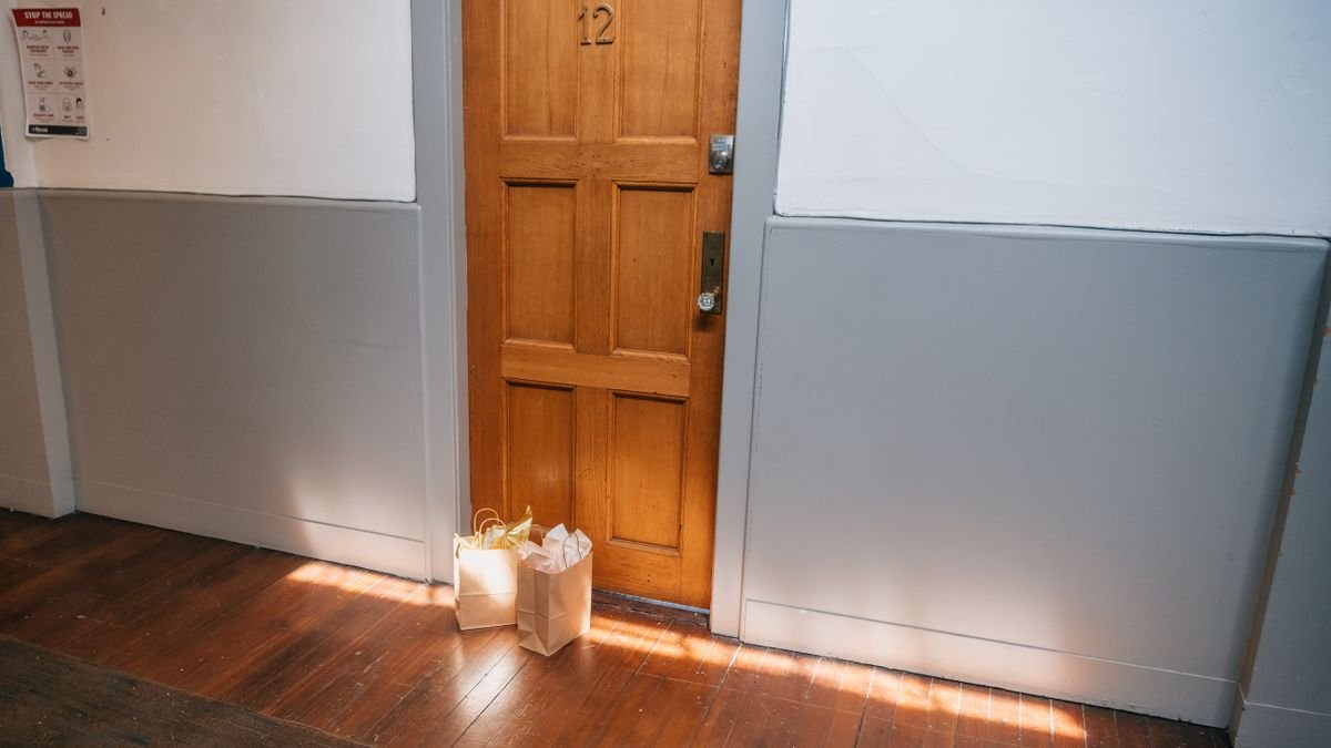 paper grocery bags left outside an apartment door after delivery