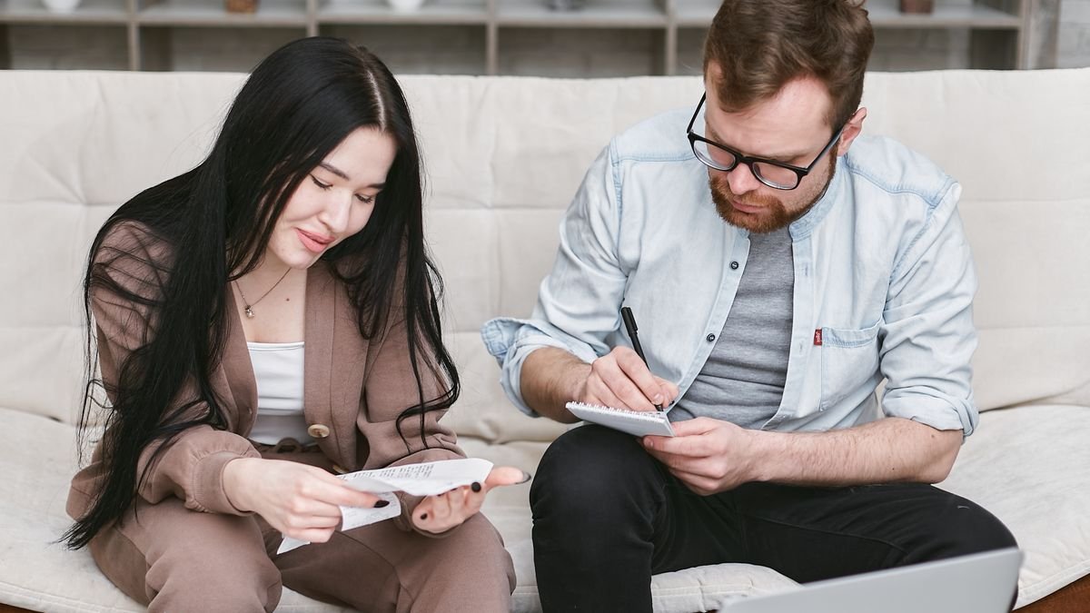 couple going over receipts and notes together to split bills